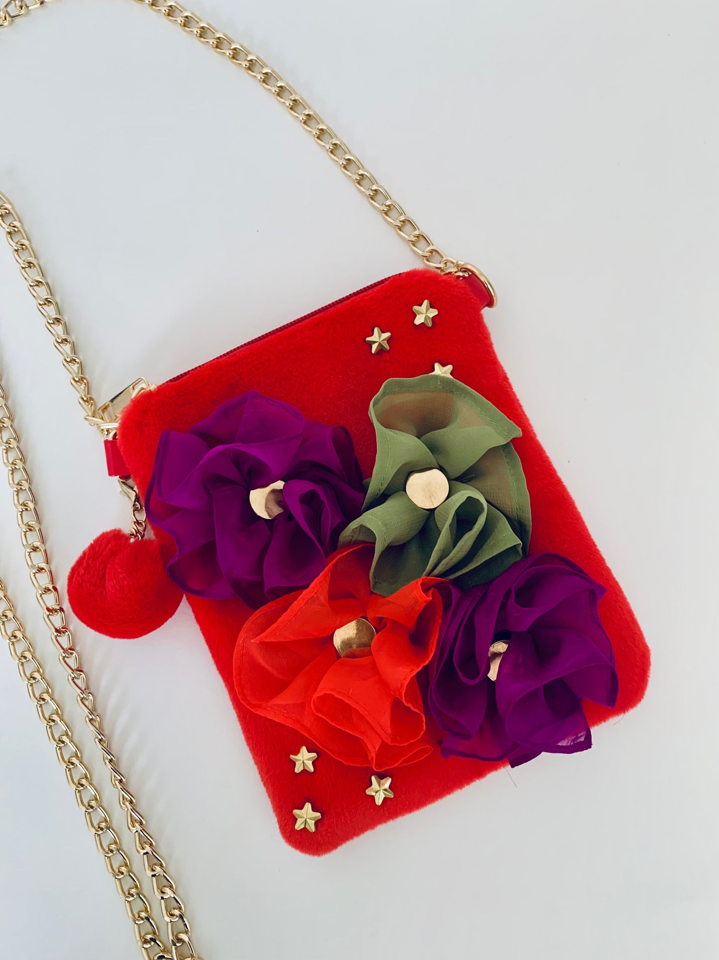 Red Crossbody Handbag with Floral Decorations and a Gold Chain